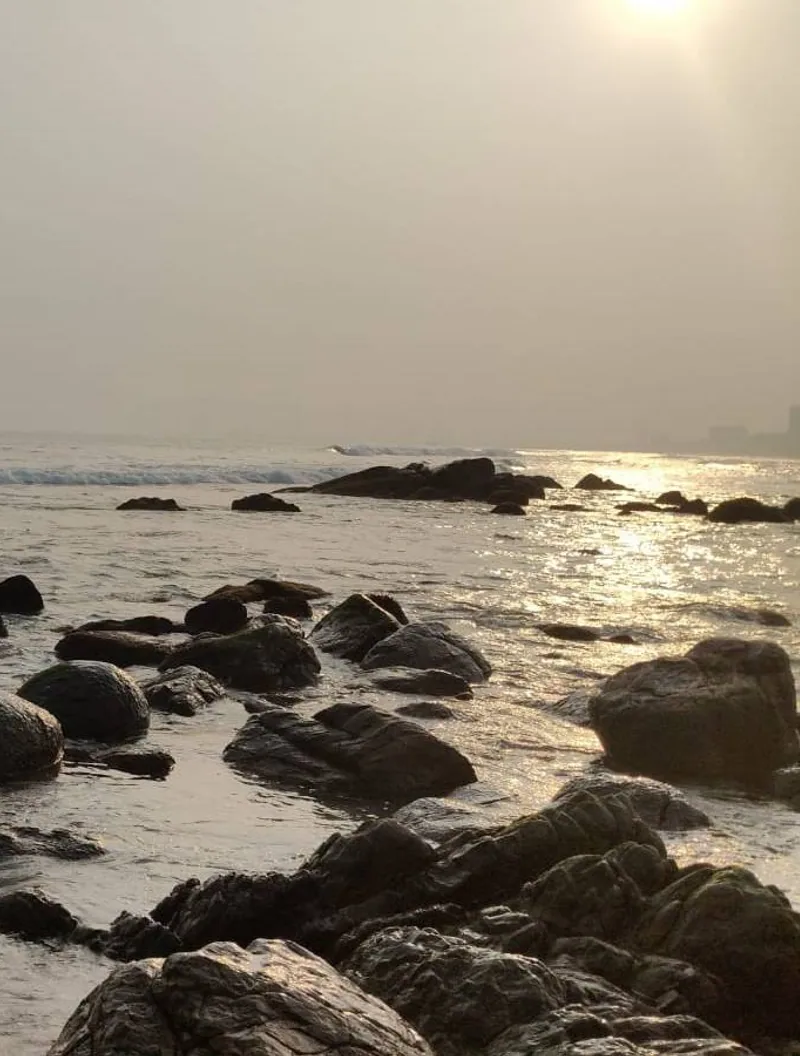 The sandy shoreline and sea at RK Beach in Visakhapatnam